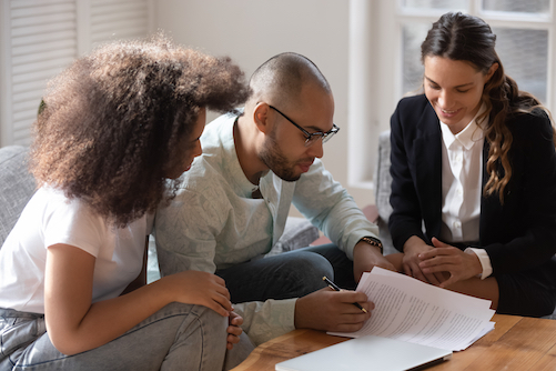 Couple at Mortgage Broker Signing Papers